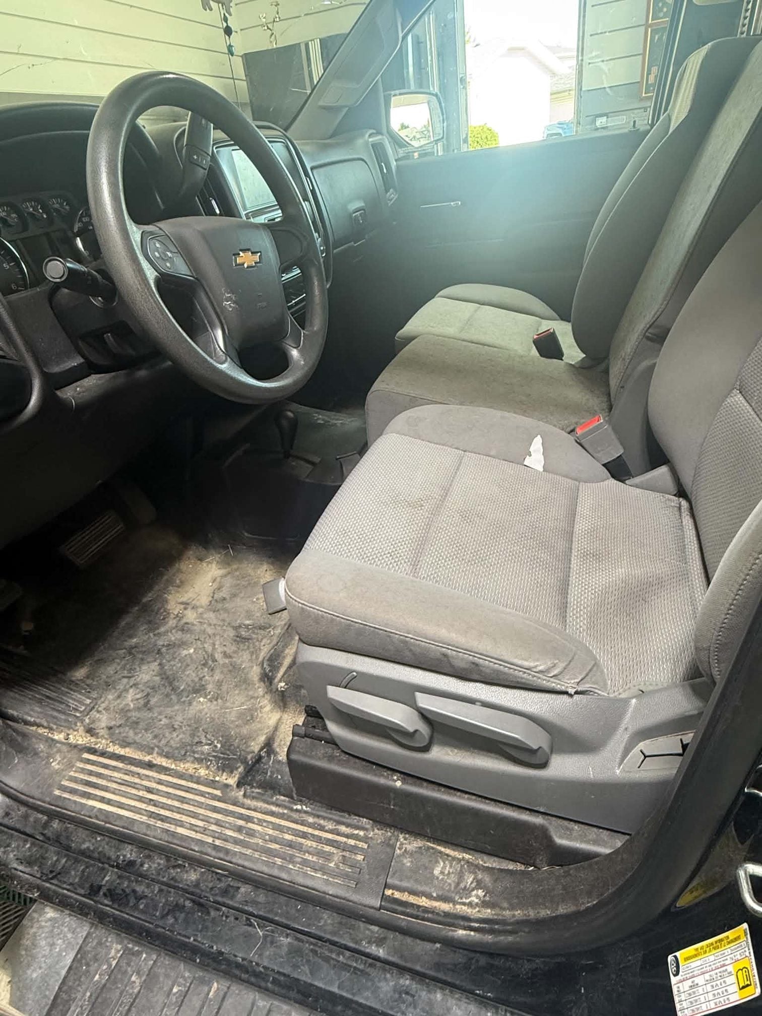 Chevrolet Silverado front seat and floor before detailing, dust and debris in the seams