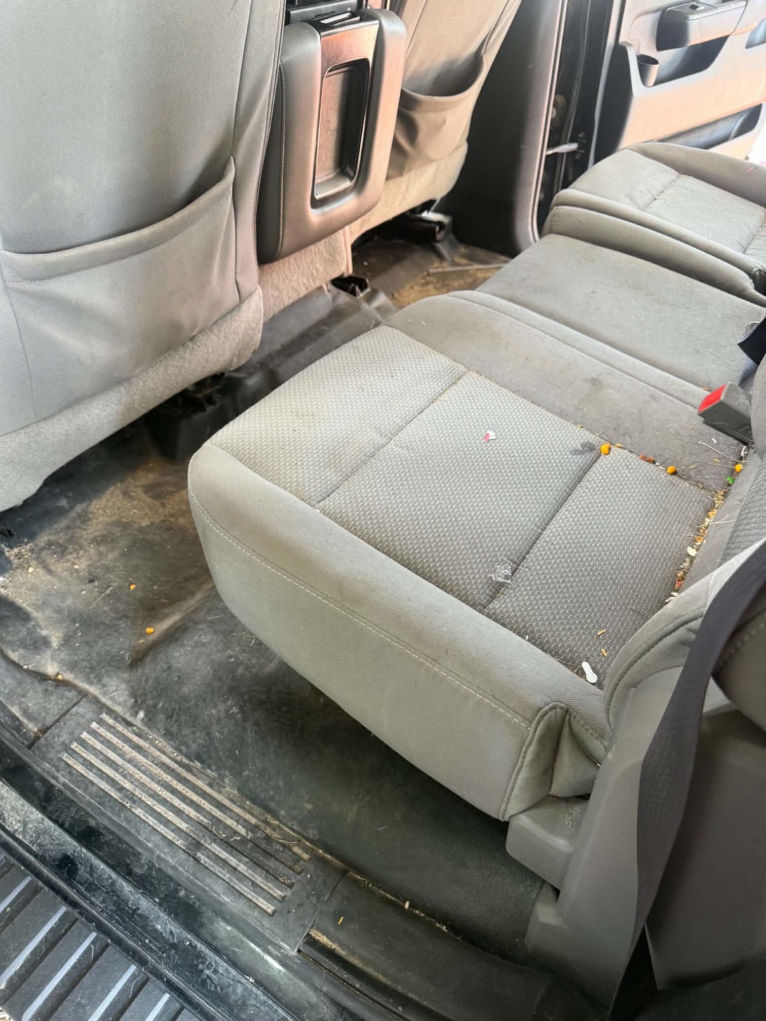 Chevrolet Silverado seat heavily soiled with embedded debris before cleaning
